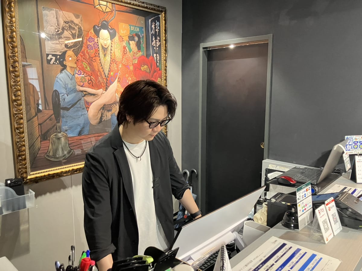 イケメン製作所店内にて予約を確認する伊集院氏